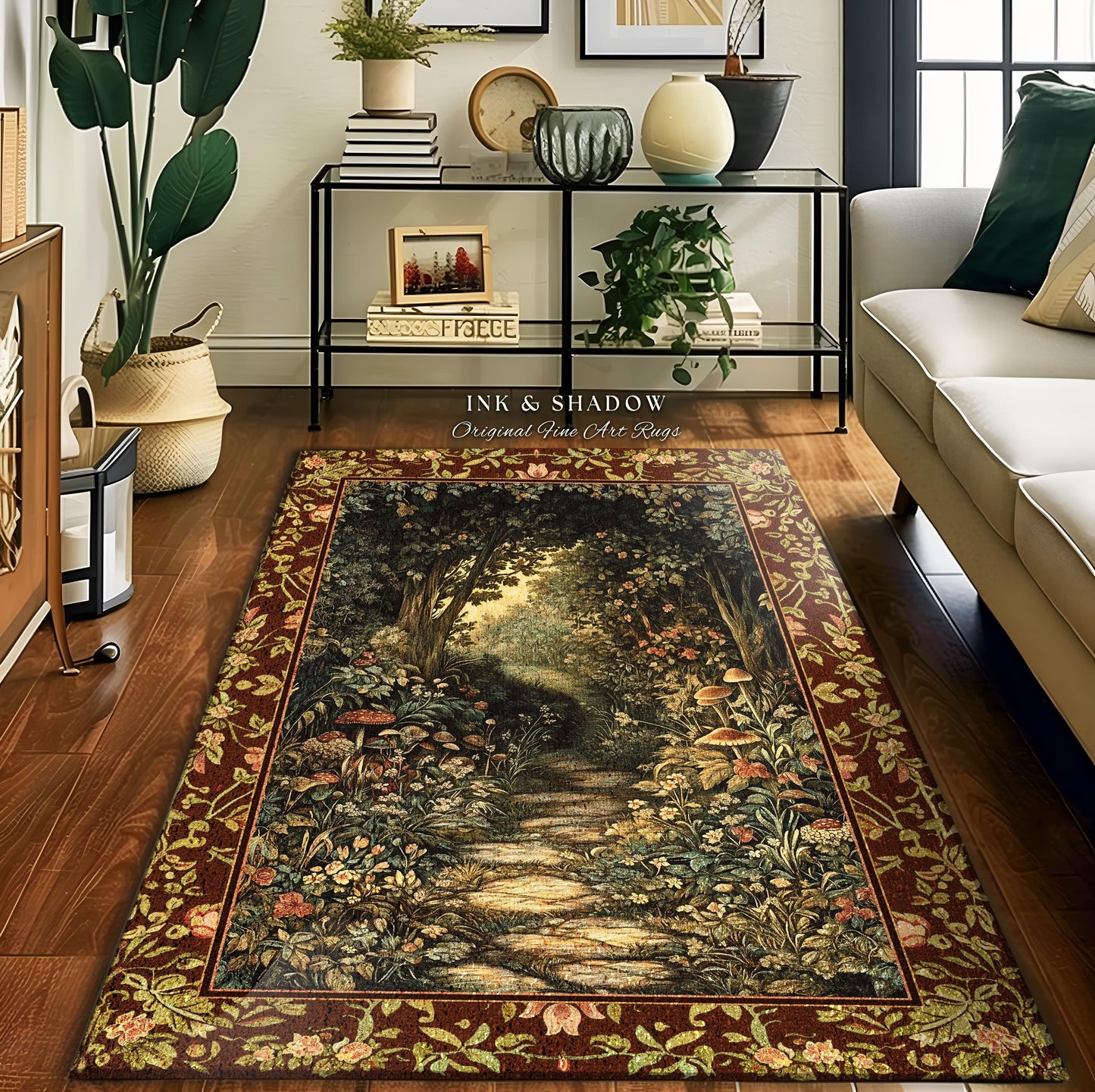 May include: A brown and gold area rug features a tapestry-style nature scene. The rug depicts a path winding through a lush forest with vibrant green foliage, flowers, and mushrooms. The border is a repeating floral pattern in shades of brown and gold. The text 'INK & SHADOW Original Fine Art Rugs' is visible. The rug is displayed on a hardwood floor in a living room setting.