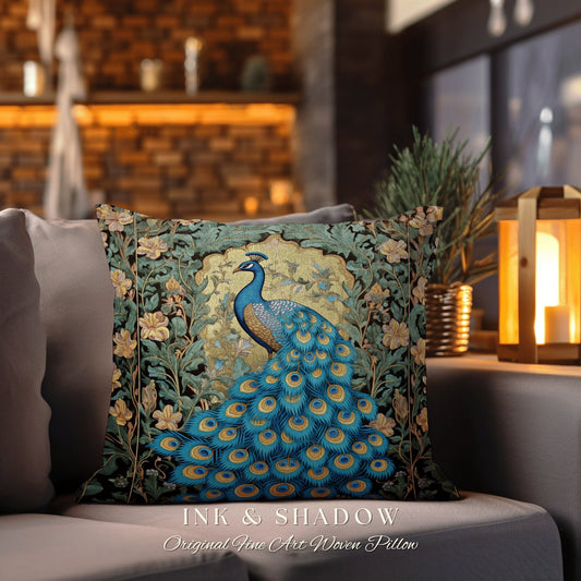 May include: A square throw pillow features a woven tapestry design of a peacock with its tail feathers spread. The peacock is predominantly teal and blue, set against a dark background with gold accents.  Surrounding the peacock are stylized floral elements in shades of green and yellow. The pillow has a dark border. Text on the bottom reads: &#39;INK & SHADOW Original Fine Art Woven Pillow&#39;.
