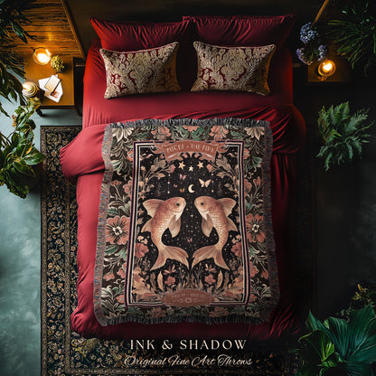 May include: A black and gold woven throw blanket with a tapestry design featuring two gold fish with a crescent moon and stars in the background. The blanket has a fringe border and the text &#39;Pisces - The Fish&#39; in a gold font. The text &#39;Ink & Shadow Original Fine Art Throws&#39; is at the bottom of the blanket.