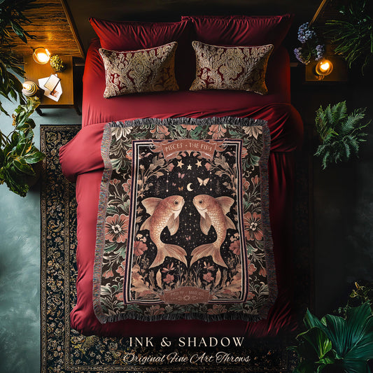 May include: A black and gold woven throw blanket with a tapestry design featuring two gold fish with a crescent moon and stars in the background. The blanket has a fringe border and the text &#39;Pisces - The Fish&#39; in a gold font. The text &#39;Ink & Shadow Original Fine Art Throws&#39; is at the bottom of the blanket.