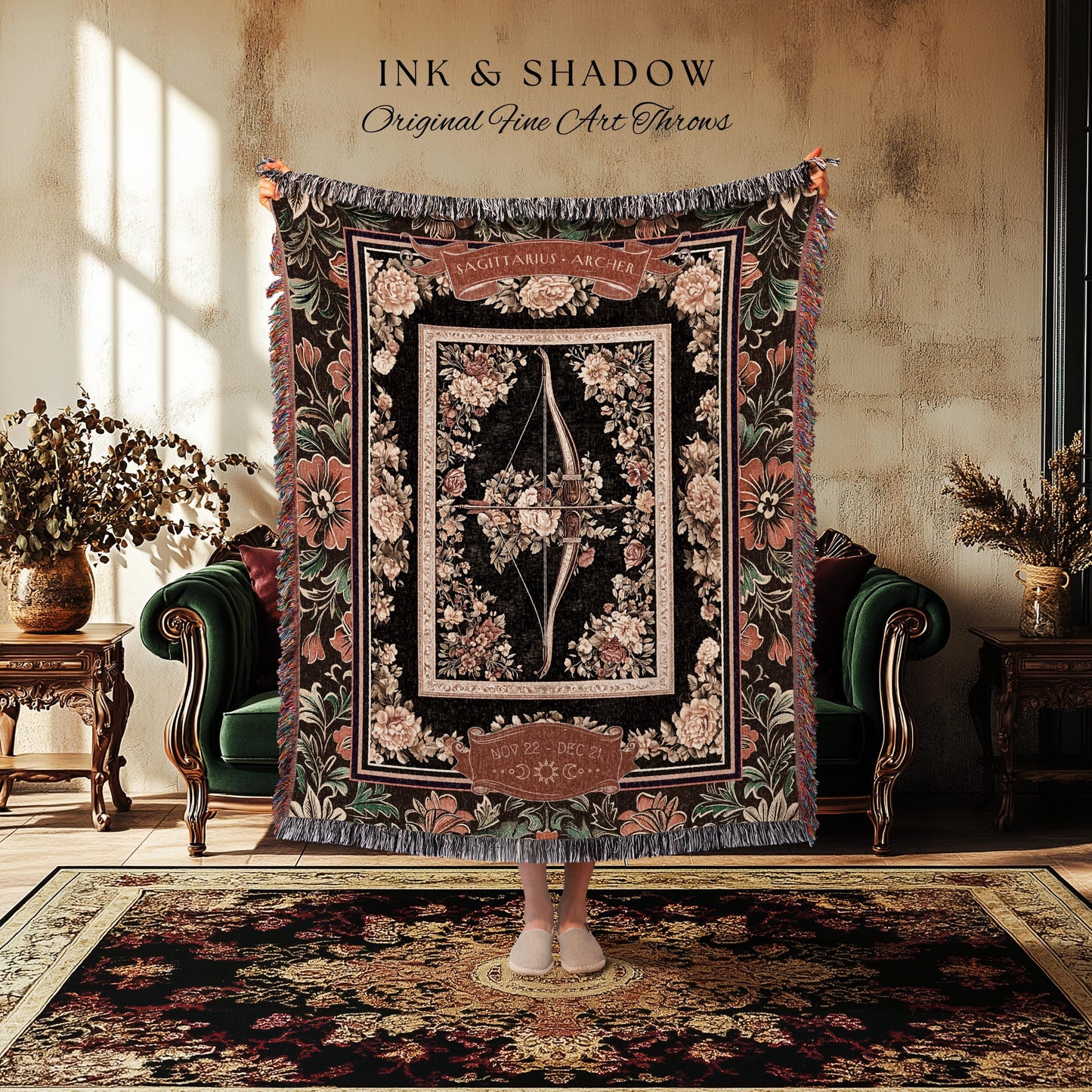 May include: A black and brown tapestry throw blanket with a floral design. The center of the blanket features a bow and arrow with the words &#39;Sagittarius - Archer&#39; above it. The blanket has a fringe border.