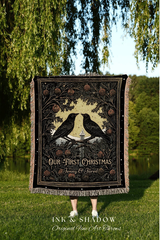 May include: A black woven throw blanket with a gold and white design. The design features two black birds perched on a branch with a small house in the background. The text on the blanket reads &#39;Our First Christmas Jenny & Jared&#39; and &#39;Ink & Shadow Original Fine Art Throws&#39;.
