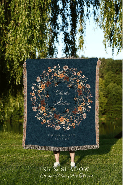 May include: A woven throw blanket with a dark blue background and a floral wreath design in shades of orange, yellow, and brown. The wreath encircles the text &#39;Charlie & Adeline&#39; and &#39;FOREVER & ALWAYS 09.17.24&#39;.