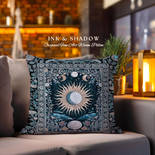 May include: A square pillow with a dark blue background and a woven design featuring a sun and moon with floral accents. The pillow has a border with a light blue and white floral pattern. The text &#39;INK & SHADOW Original Fine Art Woven Pillow&#39; is printed on the pillow.