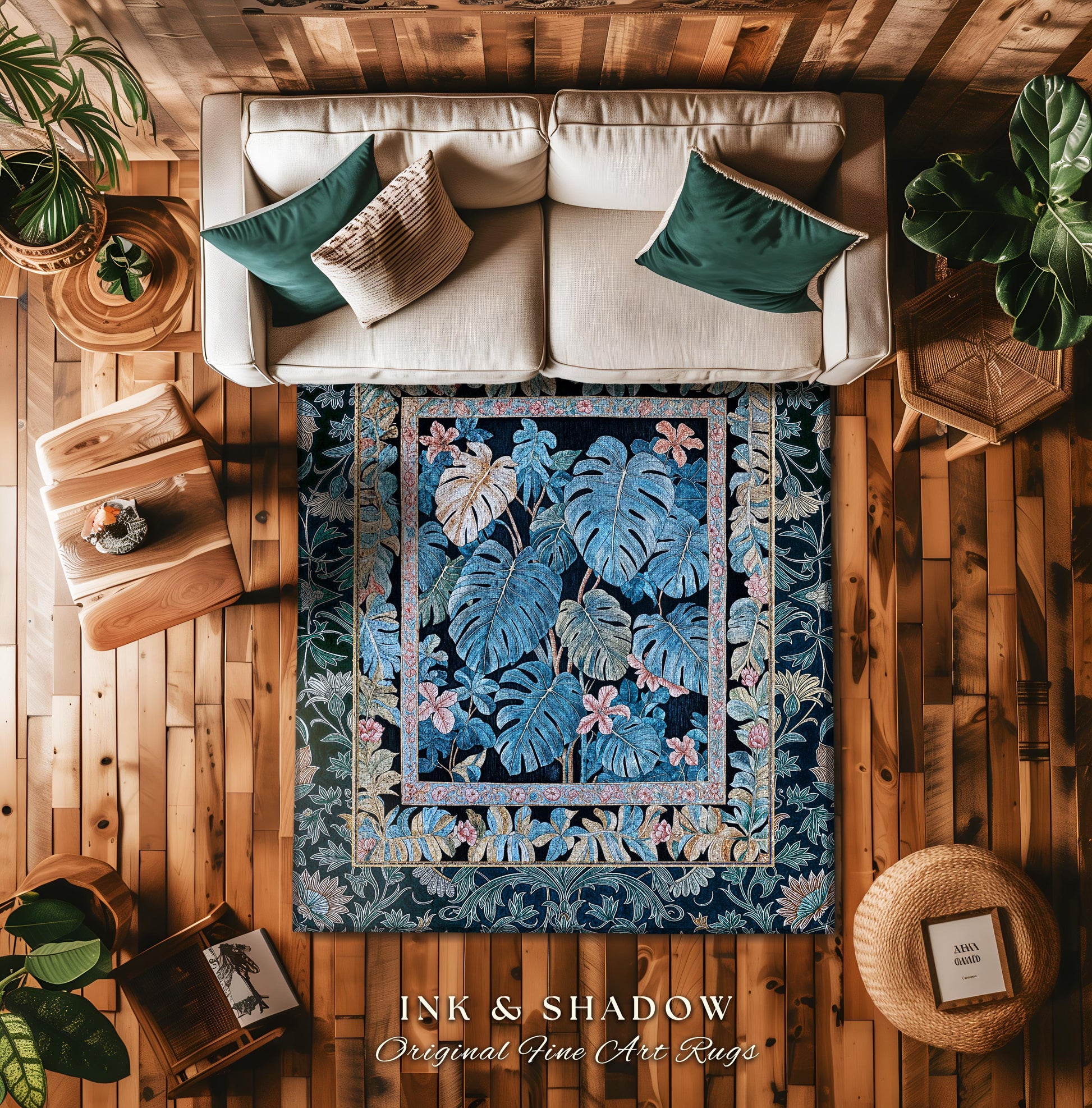 May include: A blue and black rug with a floral pattern. The rug has a border of pink and yellow flowers. The rug is on a wooden floor. The text on the rug reads &#39;INK & SHADOW Original Fine Art Rugs&#39;.