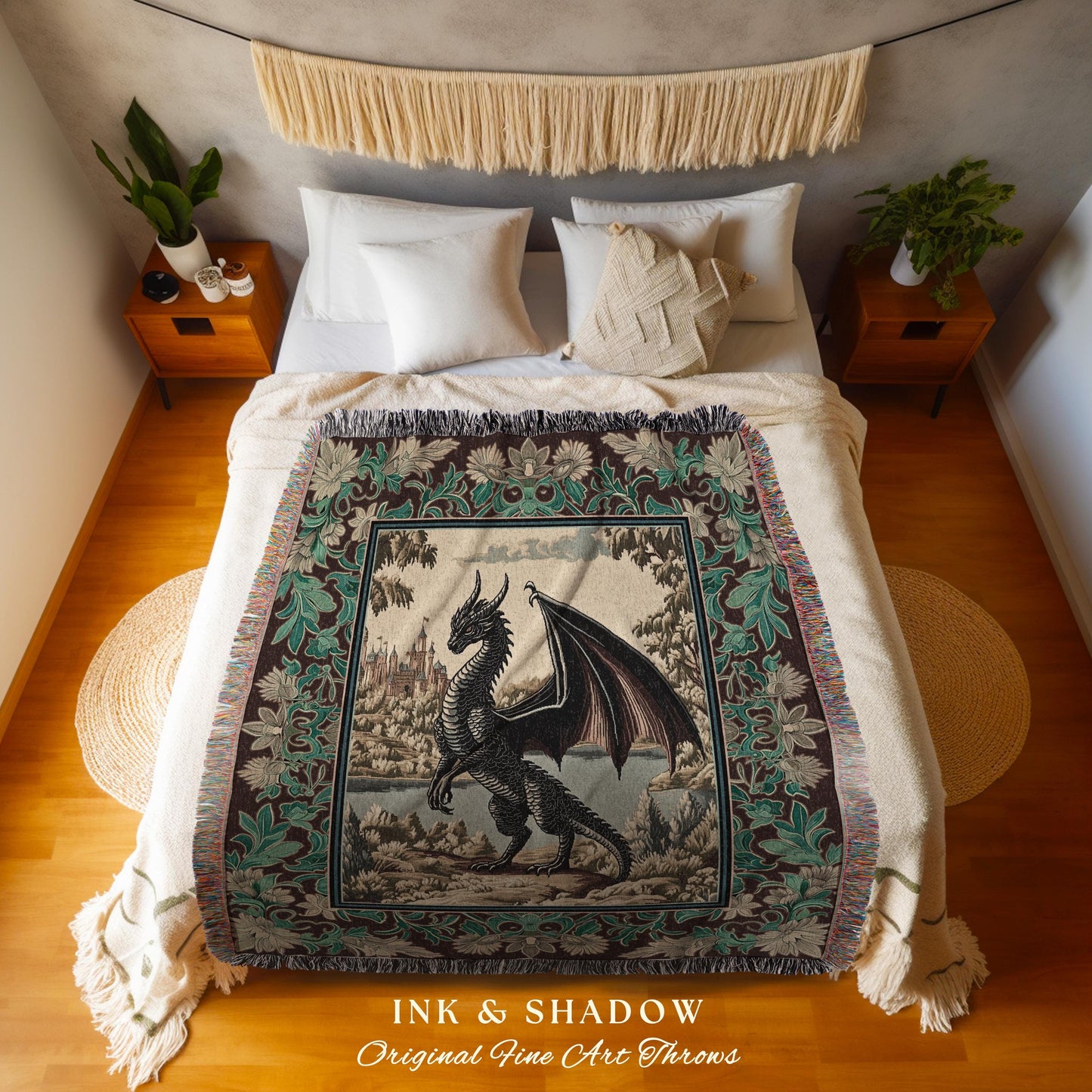 May include: A throw blanket with a tapestry design featuring a black dragon in a forest setting. The blanket has a cream background with green and brown accents. The text &#39;INK & SHADOW Original Fine Art Throws&#39; is printed at the bottom of the blanket.