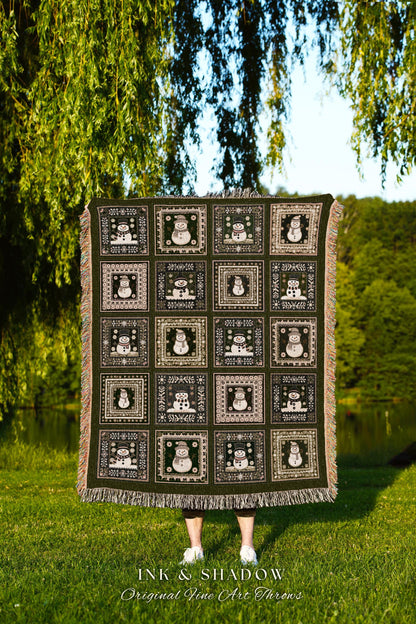 May include: A dark green woven throw blanket features a repeating pattern of framed snowmen. Each square contains a unique snowman design against a green background. The blanket has fringed edges.  The text &#39;INK & SHADOW Original Fine Art Throws&#39; is visible at the bottom.