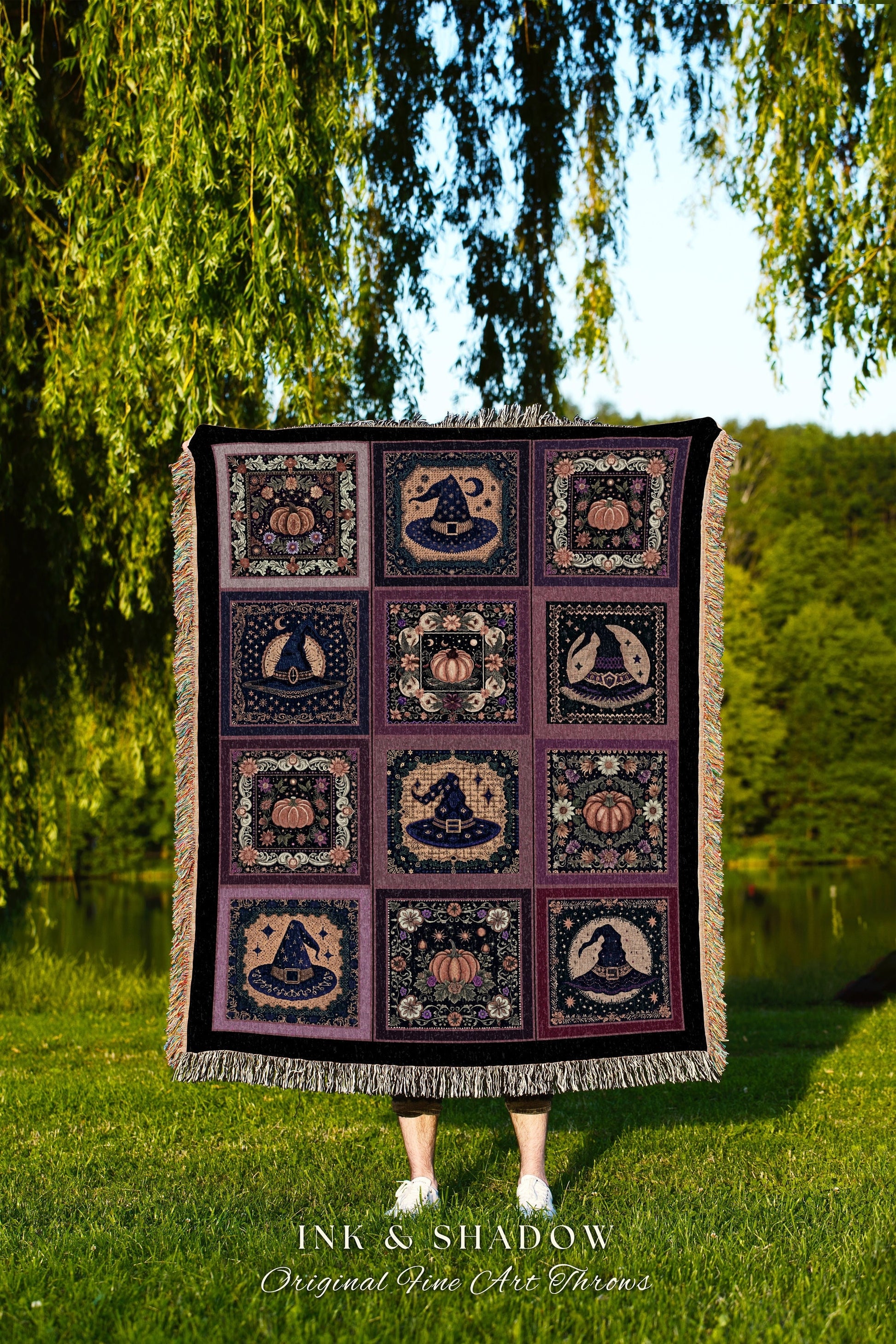 May include: A woven throw blanket with a purple and black background. The blanket has a repeating pattern of witch hats, pumpkins, and stars. The blanket is fringed on all sides. The text &#39;INK & SHADOW Original Fine Art Throws&#39; is printed at the bottom of the blanket.