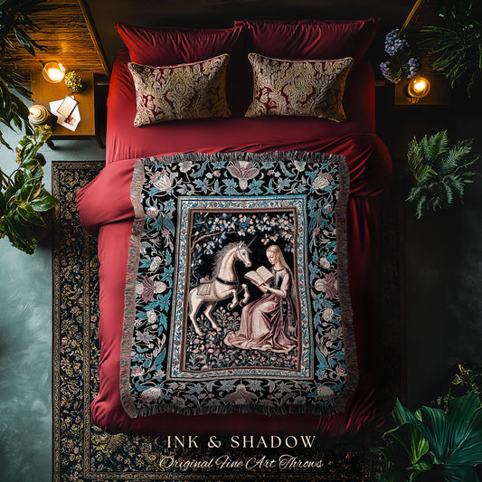May include: A black and blue tapestry throw blanket with a medieval style design featuring a unicorn and a woman reading a book. The throw blanket is displayed on a red bed with pillows and a black and white patterned rug. The text &#39;INK & SHADOW Original Fine Art Throws&#39; is visible at the bottom of the image.