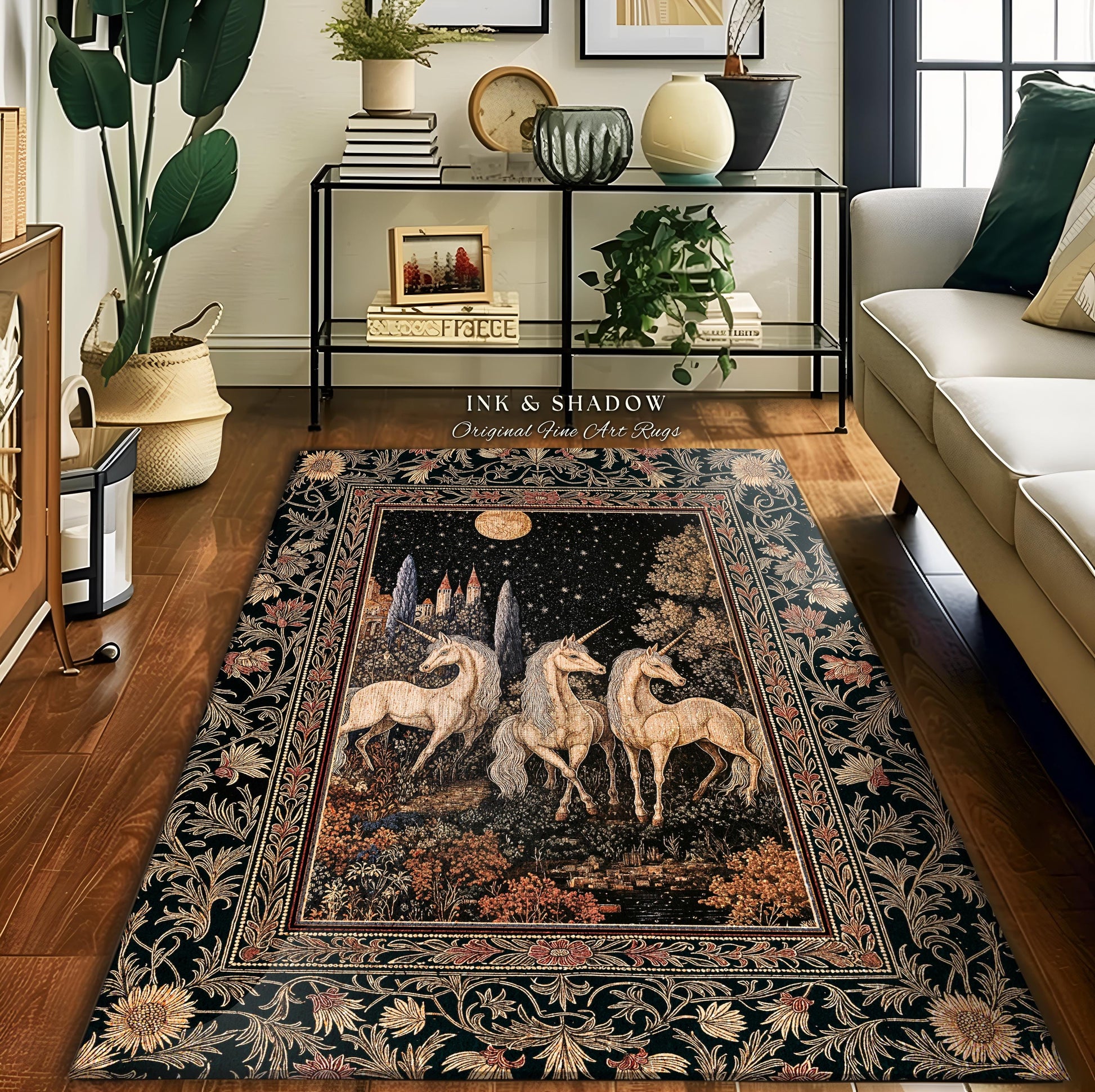 May include: A black and gold tapestry rug with a floral border. The center of the rug features a dark background with a full moon and three white unicorns. The text &#39;INK & SHADOW Original Fine Art Rugs&#39; is printed in white at the top of the rug.