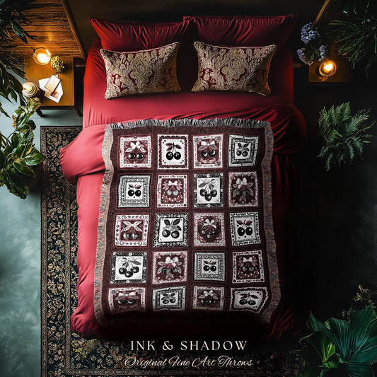May include: A red throw blanket with a pattern of black cherries in a white frame on a burgundy background. The blanket is on a red bed with two pillows with a gold and white pattern. The text &#39;INK & SHADOW Original Fine Art Throws&#39; is at the bottom of the image.