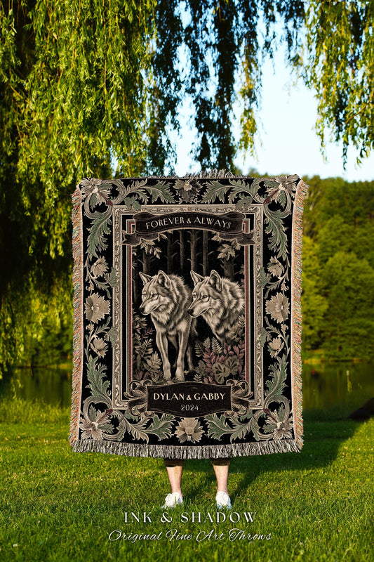 May include: A black tapestry throw blanket with a floral border. The center of the blanket features two grey wolves in a forest setting. The text on the blanket reads &#39;Forever & Always&#39;, &#39;Dylan & Gabby&#39;, and &#39;2024&#39;. The bottom of the blanket reads &#39;Ink & Shadow Original Fine Art Throws&#39;.