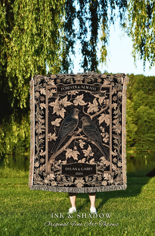 May include: A black tapestry throw blanket with a gold design. The design features two birds perched on a branch with leaves. The text on the blanket reads &#39;Forever & Always&#39;, &#39;Dylan & Gabby&#39;, &#39;2024&#39;, &#39;Ink & Shadow&#39;, and &#39;Original Fine Art Throws&#39;.