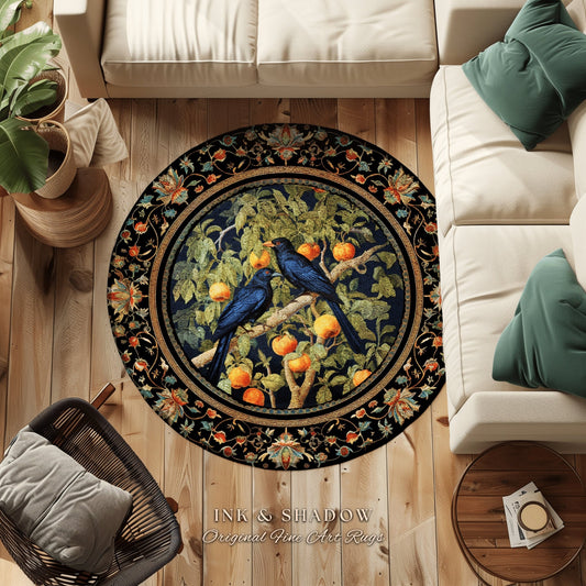 May include: A round rug with a black background and a circular design featuring a tree with blue birds and orange fruit. The rug has a border with floral designs in shades of blue, green, and gold. The text &#39;INK & SHADOW Original Fine Art Rugs&#39; is displayed below the rug.