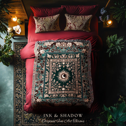 May include: A green and brown tapestry throw blanket with a sun and moon design. The throw blanket is on a red bed with two pillows. The throw blanket has a fringe border and the text &#39;INK & SHADOW Original Fine Art Throws&#39; is at the bottom of the image.
