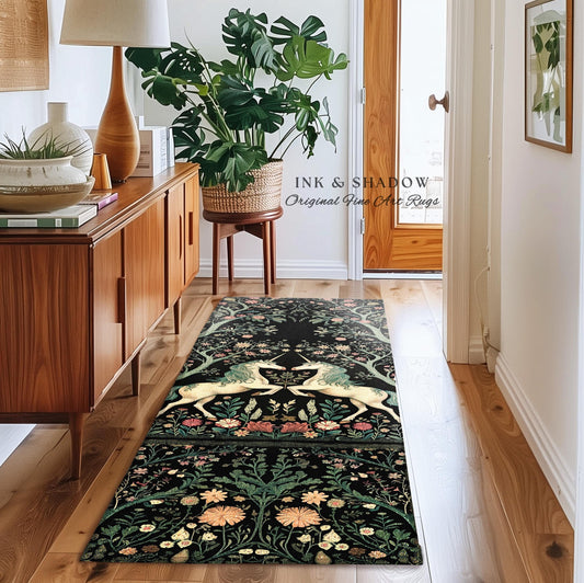 May include: A black and ivory area rug featuring a tapestry-style design of two unicorns amidst a floral border. The rug has a dark background with light-colored flowers and greenery.  The text &#39;INK & SHADOW Original Fine Art Rugs&#39; is visible. The rug is displayed in a hallway setting with mid-century modern furniture.
