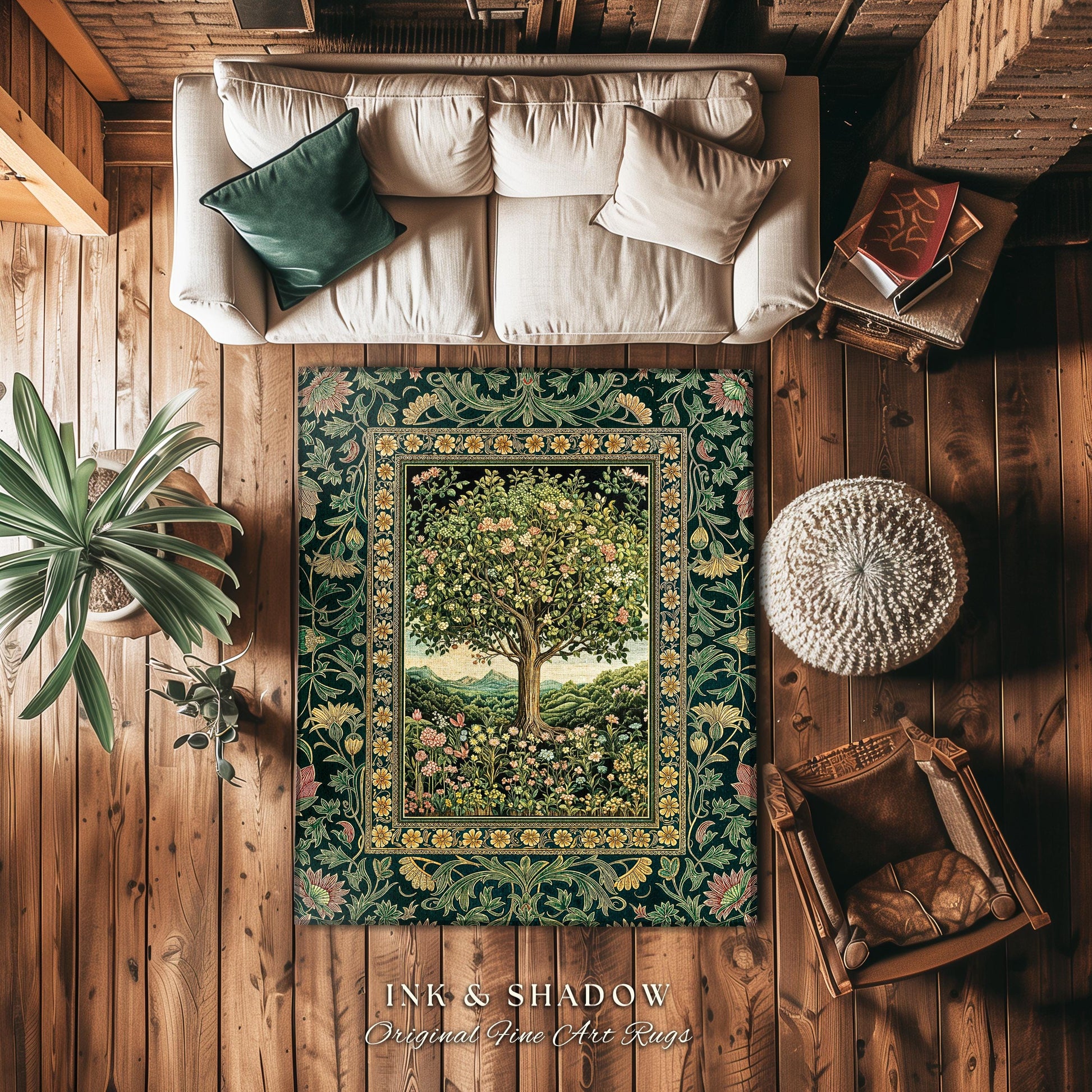 May include: A green and gold rug with a floral design and a tree in the center. The rug is on a wooden floor with a white couch, a brown chair, and a white ottoman. The rug has the text &#39;INK & SHADOW Original Fine Art Rugs&#39; at the bottom.