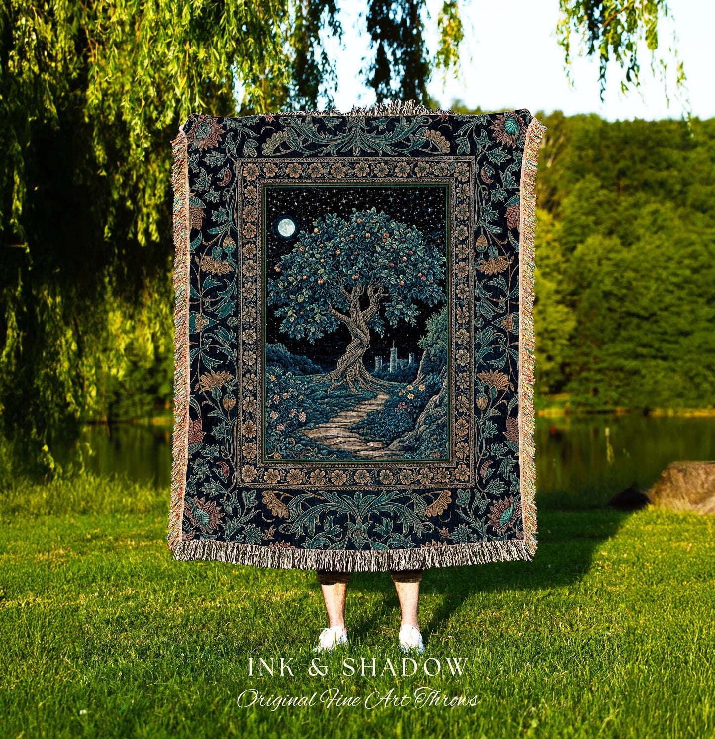 May include: A tapestry throw blanket featuring a detailed illustration of a tree under a starry night sky with a full moon. The blanket has a dark background with floral borders and fringe. The text "INK & SHADOW Original Fine Art Throws" is at the bottom.