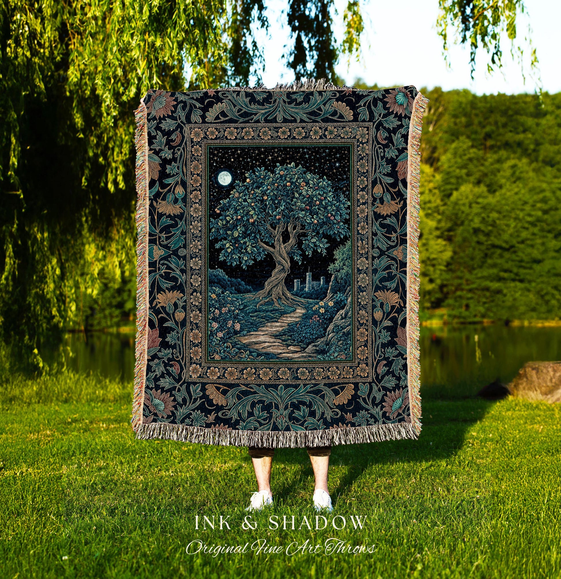 May include: A tapestry throw blanket featuring a detailed illustration of a tree under a starry night sky with a full moon. The blanket has a dark background with floral borders and fringe. The text "INK & SHADOW Original Fine Art Throws" is at the bottom.