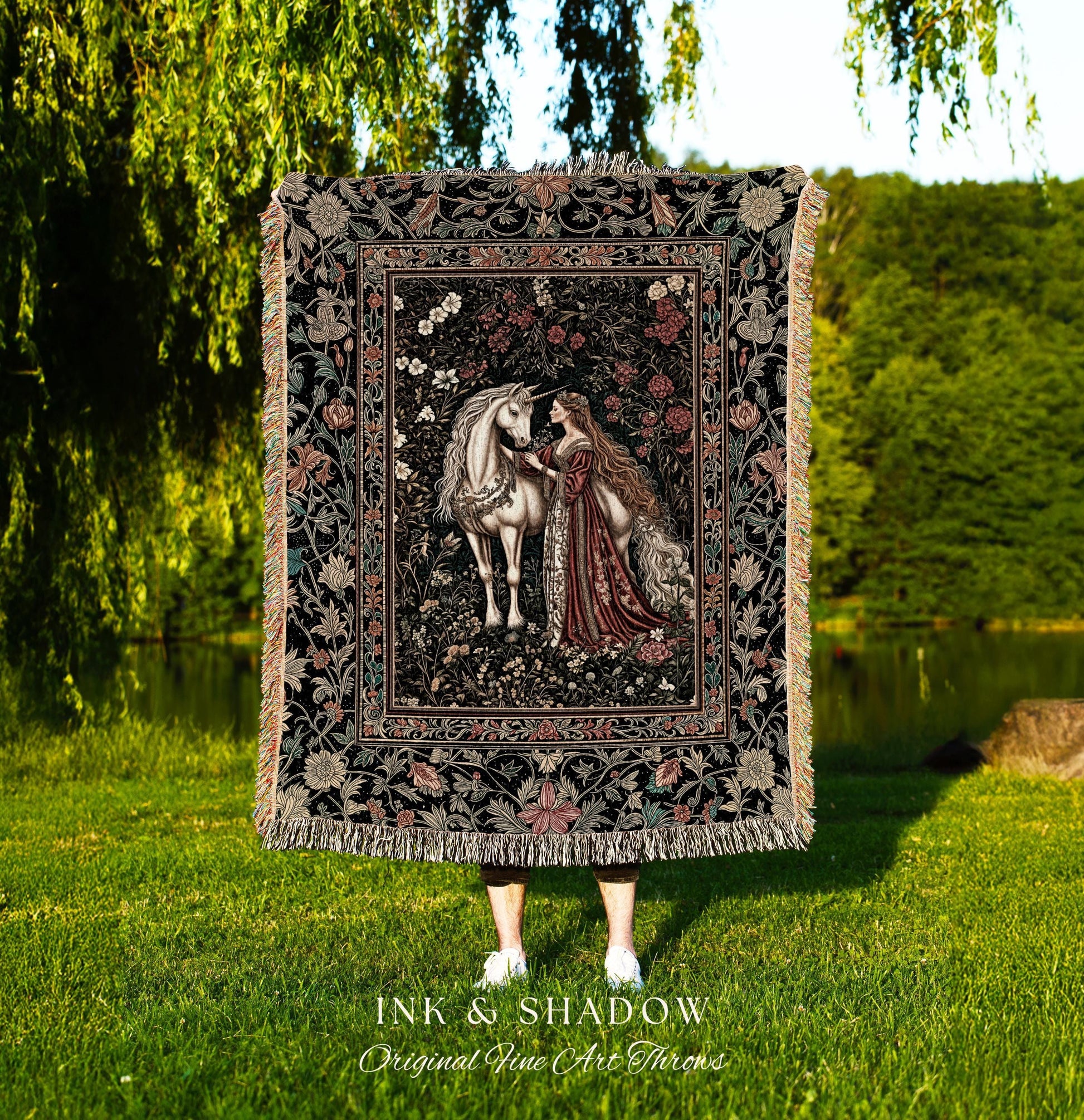 May include: A tapestry throw blanket with a black background and a floral design. The center of the tapestry features a white unicorn and a woman in a red dress. The text 'INK & SHADOW Original Fine Art Throws' is at the bottom of the image.