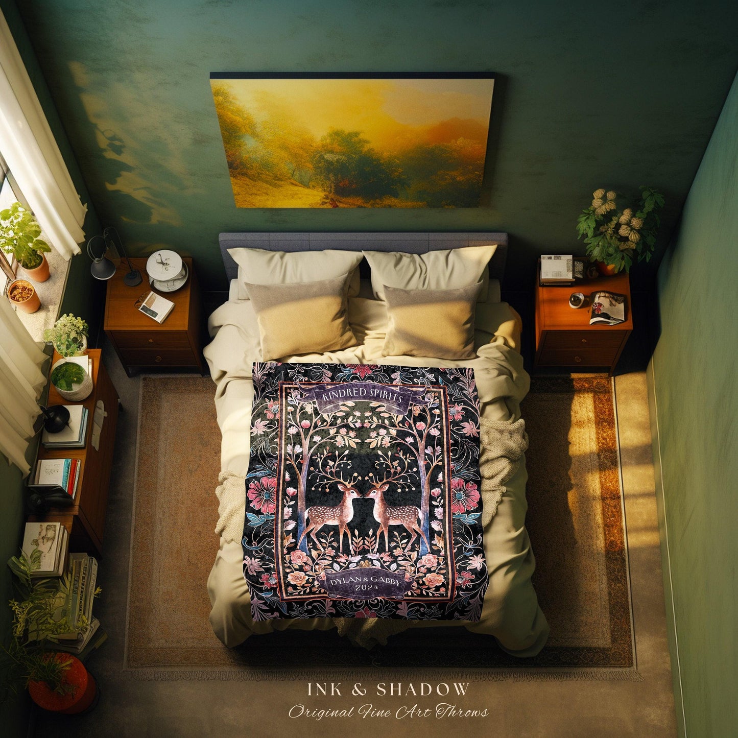May include: A black throw blanket with a floral design featuring two deer with antlers. The blanket has the words 'Kindred Spirits' in a circle at the top and 'Dylan & Gabby 2022' at the bottom. The blanket is on a bed with white pillows and a gray headboard. The blanket is part of the 'Ink & Shadow Original Fine Art Throws' collection.