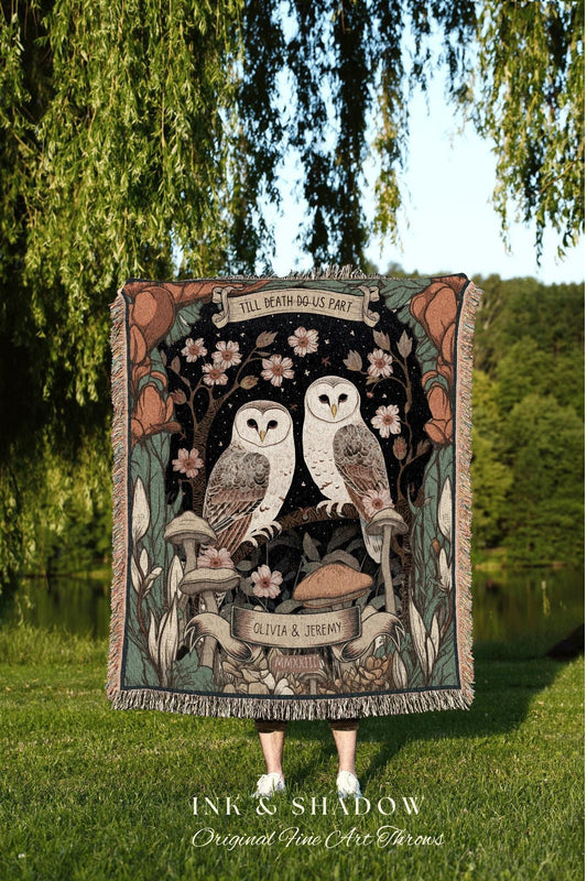 May include: A woven tapestry throw blanket with a dark background featuring two white owls perched on a branch with flowers and mushrooms. The tapestry has the text 'Till Death Do Us Part', 'Olivia & Jeremy', and 'MMXXILL'.