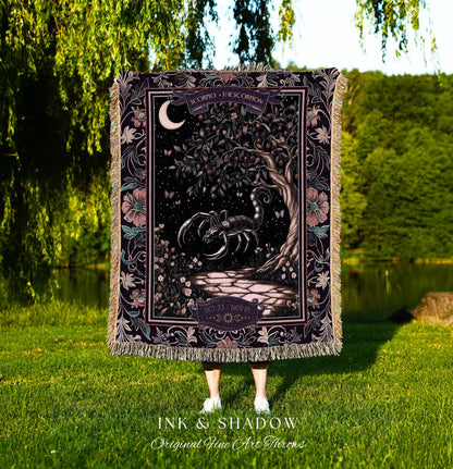 May include: A tapestry throw blanket with a black scorpion design. The scorpion is surrounded by a dark green tree with a crescent moon in the background. The tapestry has a floral border with pink and purple flowers. The text on the tapestry reads 'Scorpio - The Scorpion' and 'Oct 23 - Nov 21'. The tapestry is made by Ink & Shadow Original Fine Art Throws.