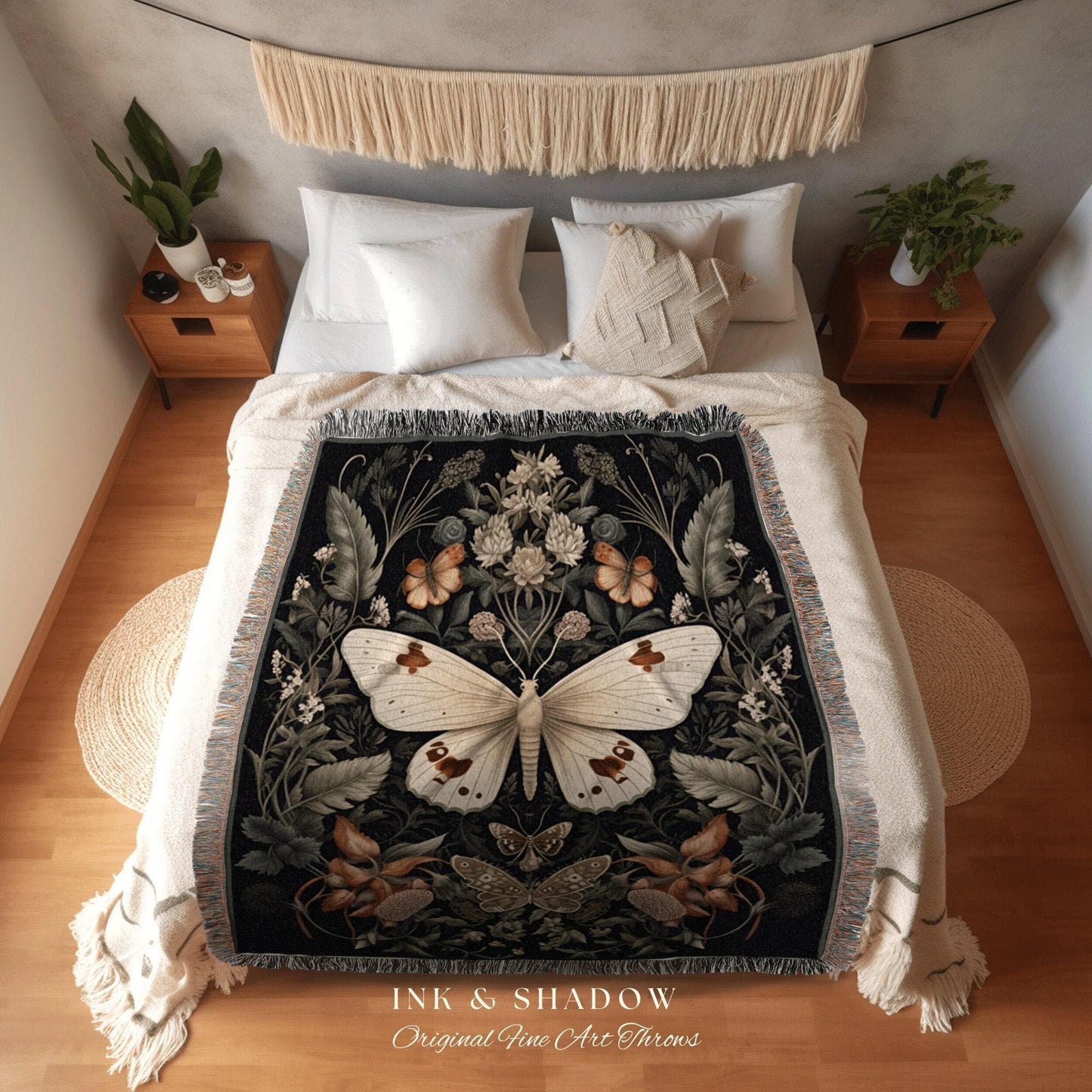 May include: A black throw blanket with a large white butterfly design, surrounded by floral and butterfly motifs. The blanket has a fringed edge and is displayed on a bed with white bedding. The text "INK & SHADOW Original Fine Art Throws" is at the bottom.