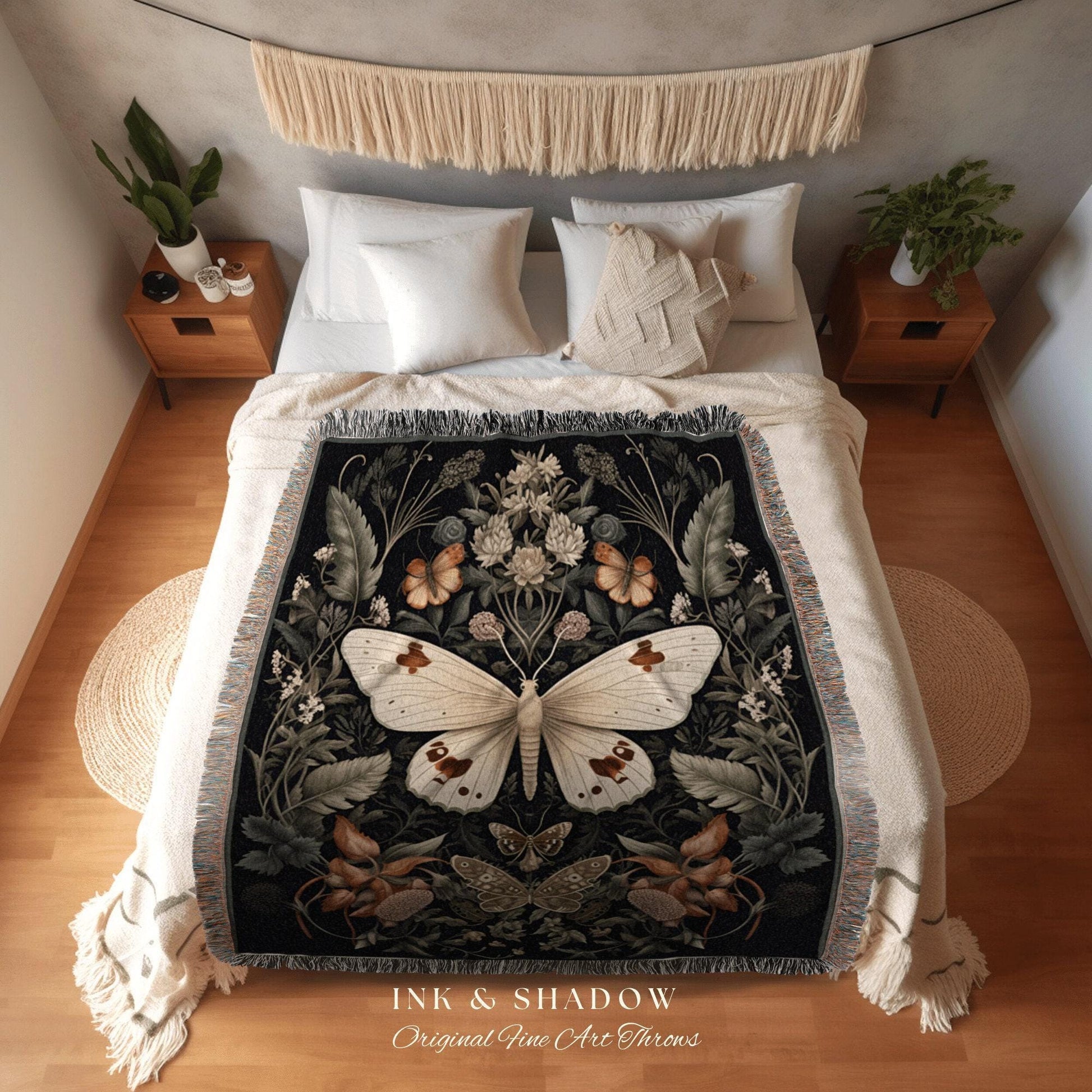 May include: A black throw blanket with a large white butterfly design, surrounded by floral and butterfly motifs. The blanket has a fringed edge and is displayed on a bed with white bedding. The text "INK & SHADOW Original Fine Art Throws" is at the bottom.