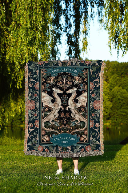 May include: A decorative throw blanket featuring a symmetrical design of two white dragons facing each other. The blanket has a dark teal background with floral and scrollwork details. The text "Eternally Yours" and "Dylan & Gabby 2024" are displayed on the blanket.