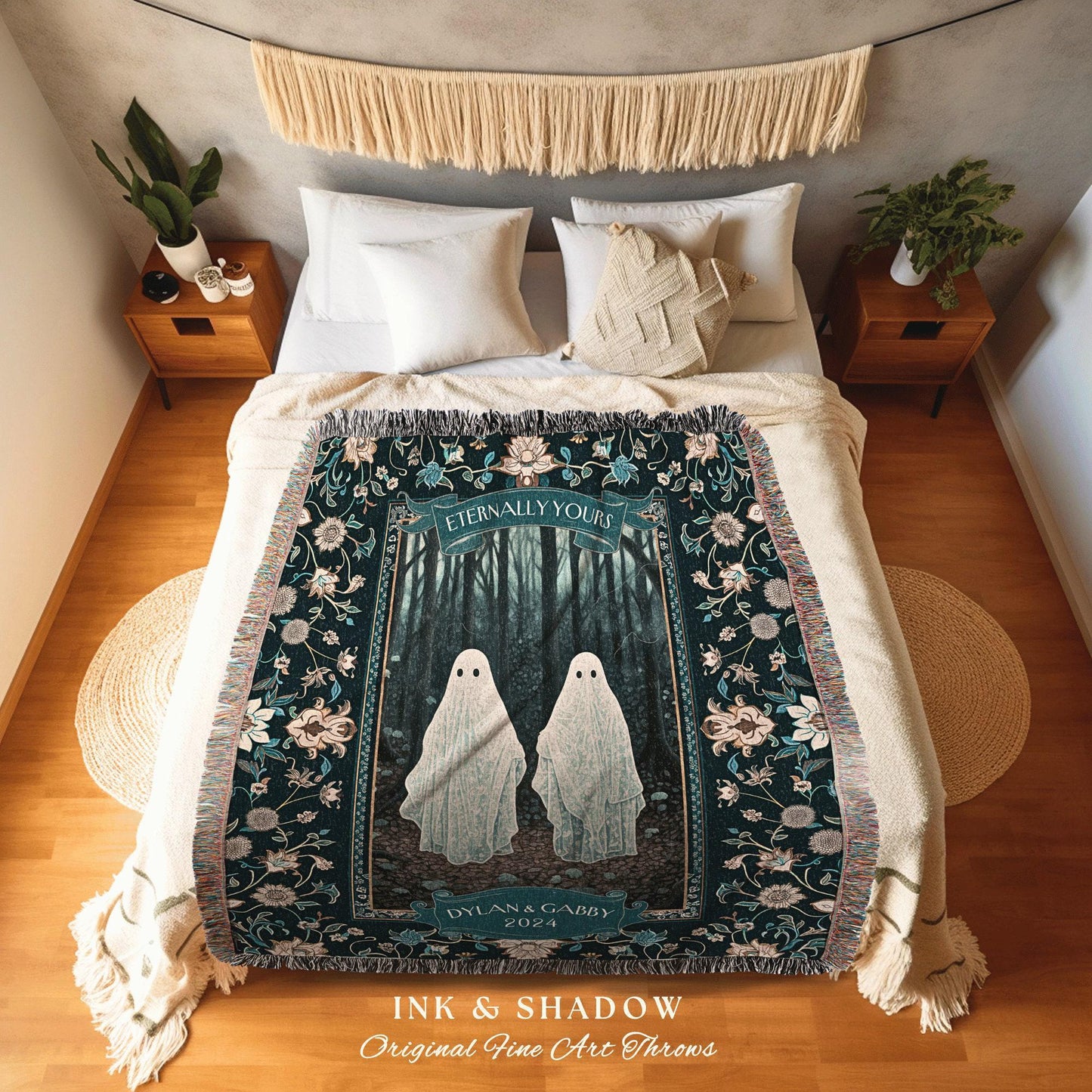 May include: A dark green woven throw blanket with a floral border. The center of the blanket features a white rectangular frame with a dark green forest scene and two white ghosts. The text 'Eternally Yours' is at the top of the frame. The text 'Dylan & Gabby 2024' is at the bottom of the frame. The text 'Ink & Shadow Original Fine Art Throws' is at the bottom of the blanket.