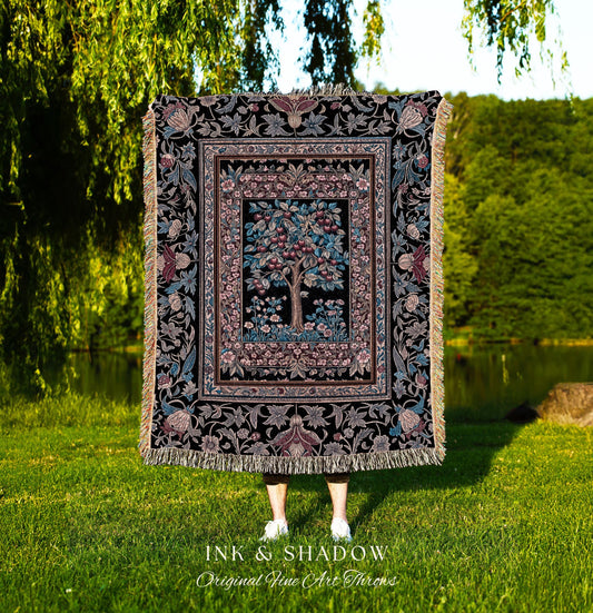 May include: A woven tapestry throw blanket with a black background and a colorful floral pattern. The center of the blanket features a tree with red and blue fruit. The blanket has fringe along the edges. The text 'INK & SHADOW Original Fine Art Throws' is visible at the bottom of the image.