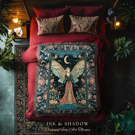 May include: A woven tapestry throw blanket with a dark blue background and a floral design. The center of the blanket features a fairy with wings and a crescent moon. The text on the blanket reads 'Virgo - The Maiden' and 'Ink & Shadow Original Fine Art Throws'.
