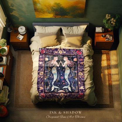 May include: A dark purple throw blanket features an illustration of two mermaids with flowing hair, tails, and hands clasped together.  The mermaids are surrounded by floral details and a dark blue starry night sky. The blanket is displayed on a bed with beige bedding and pillows.  The text 'INK & SHADOW Original Fine Art Throws' is visible at the bottom of the image.