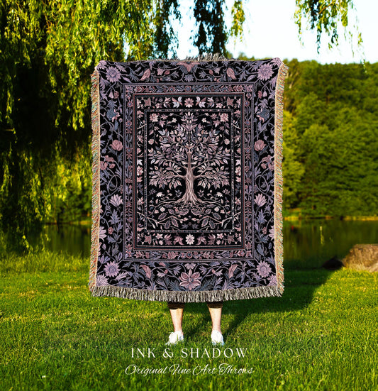 May include: A black and purple throw blanket with a tree of life design. The blanket has a floral border and fringe. The text "INK & SHADOW Original Fine Art Throws" is at the bottom.