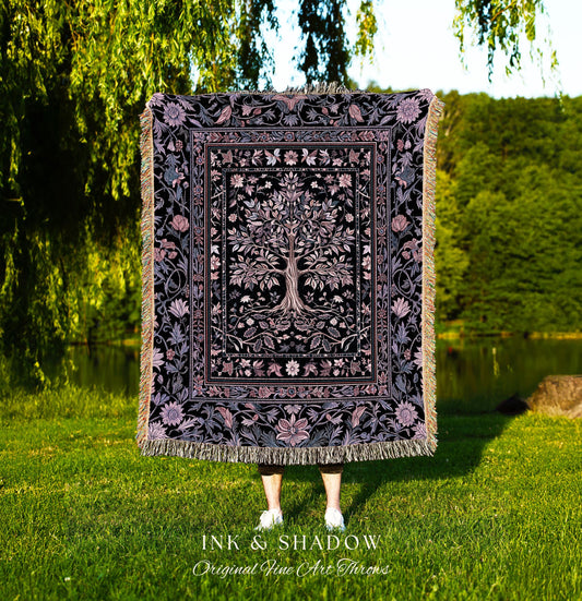 May include: A black and purple throw blanket with a tree of life design. The blanket has a floral border and fringe. The text "INK & SHADOW Original Fine Art Throws" is at the bottom.