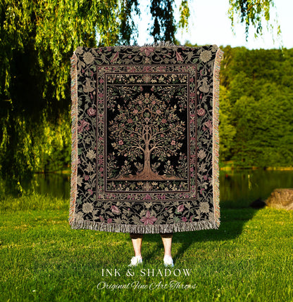 May include: A black throw blanket with a tree of life design, framed by floral patterns in pink, green, and beige. The blanket has a fringed edge and the text "INK & SHADOW Original Fine Art Throws" at the bottom.