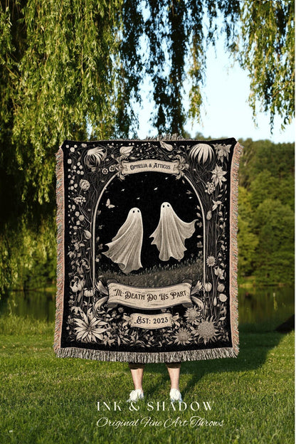 May include: A black woven throw blanket with a floral design and two white ghosts. The text on the blanket reads 'Ophelia & Atticus', 'Til Death Do Us Part', and 'Est: 2023'. The blanket is made by Ink & Shadow Original Fine Art Throws.