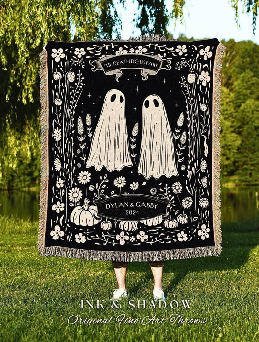 May include: Black throw blanket with a whimsical design featuring two ghost figures, flowers, and pumpkins. The text "'TIL DEATH DO US PART" is at the top, with "DYLAN & GABBY 2024" below. The blanket has a fringed edge and the words "INK & SHADOW Original Fine Art Throws" at the bottom.