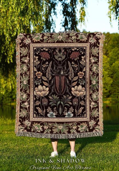 May include: A dark brown throw blanket with a central design featuring a large beetle surrounded by floral and botanical elements. The blanket has a fringed edge and the text "INK & SHADOW Original Fine Art Throws" at the bottom.