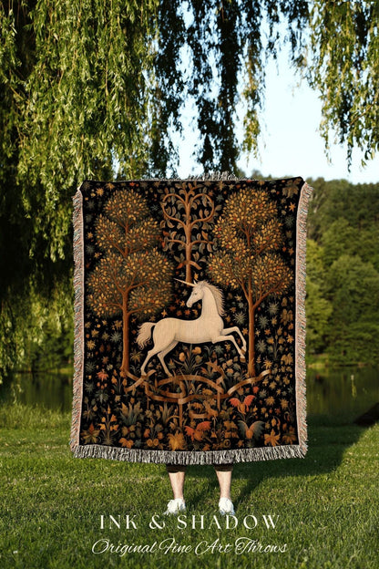 May include: A black throw blanket with a tapestry design featuring a white unicorn, trees, and floral elements. The blanket has a fringed edge and the text "INK & SHADOW Original Fine Art Throws" at the bottom.