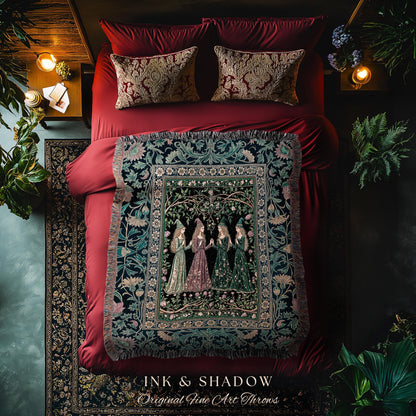 May include: A bed with red bedding, patterned pillows, and a decorative throw blanket. The throw features a detailed illustration of women in gowns. The text "INK & SHADOW Original Fine Art Throws" is at the bottom.