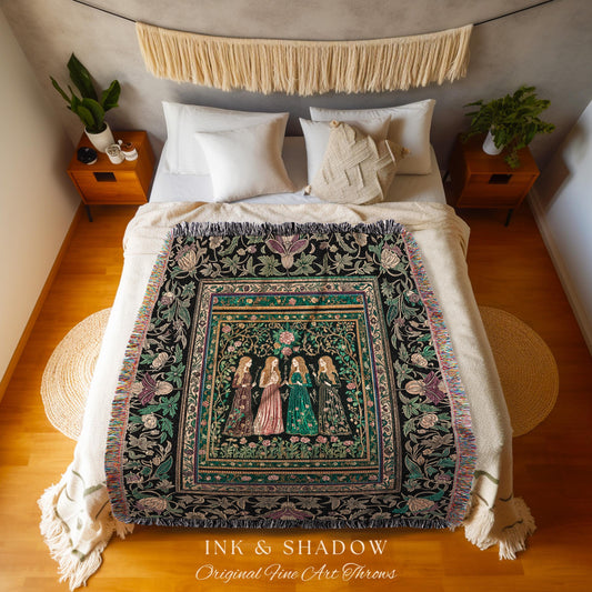 May include: A black throw blanket with a floral and figure design, featuring four women in long dresses. The blanket has a fringed edge and is displayed on a bed with white pillows and a beige bedspread. The text "INK & SHADOW Original Fine Art Throws" is at the bottom.