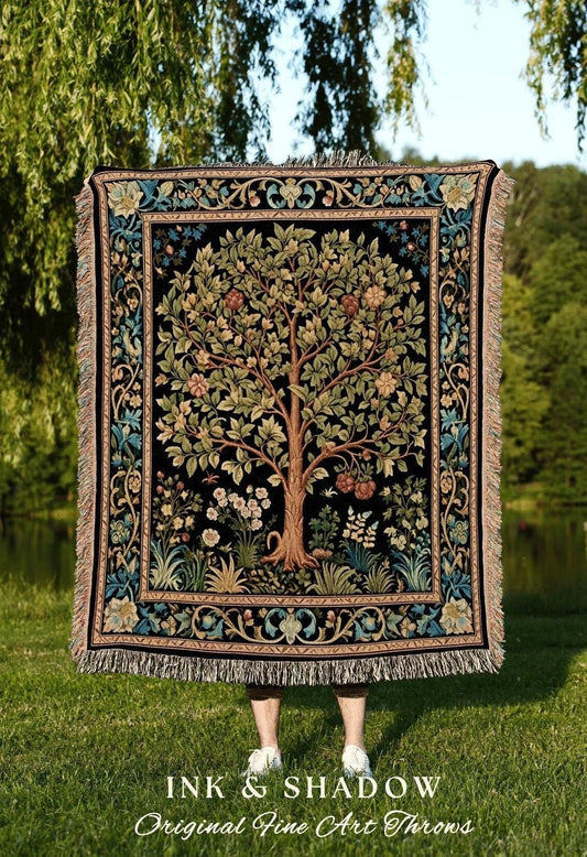 May include: A woven throw blanket with a tree of life design, featuring a black background and a detailed border with floral and foliage patterns. The throw has a fringed edge and the text "INK & SHADOW Original Fine Art Throws".