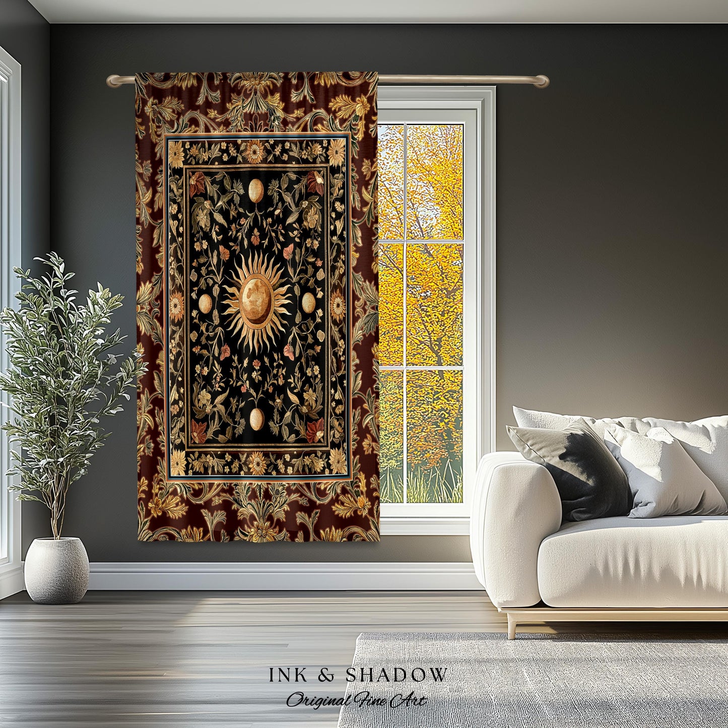 May include: A tapestry featuring a black and gold sun with a floral design. The tapestry is framed with a burgundy border and has a gold and black floral pattern. The tapestry is hanging on a gray wall.