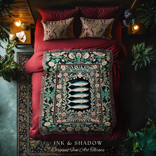 May include: A decorative throw blanket with a fish design, displayed on a red bed with matching pillows. The blanket features a black background with a floral border and four blue fish. The text "INK & SHADOW Original Fine Art Throws" is visible.