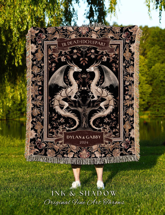 May include: A black throw blanket with a detailed floral and dragon design. The blanket features the text "TIL DEATH DO US PART" and "DYLAN & GABBY 2024". The bottom of the blanket has a fringe. The text "INK & SHADOW Original Fine Art Throws" is at the bottom.