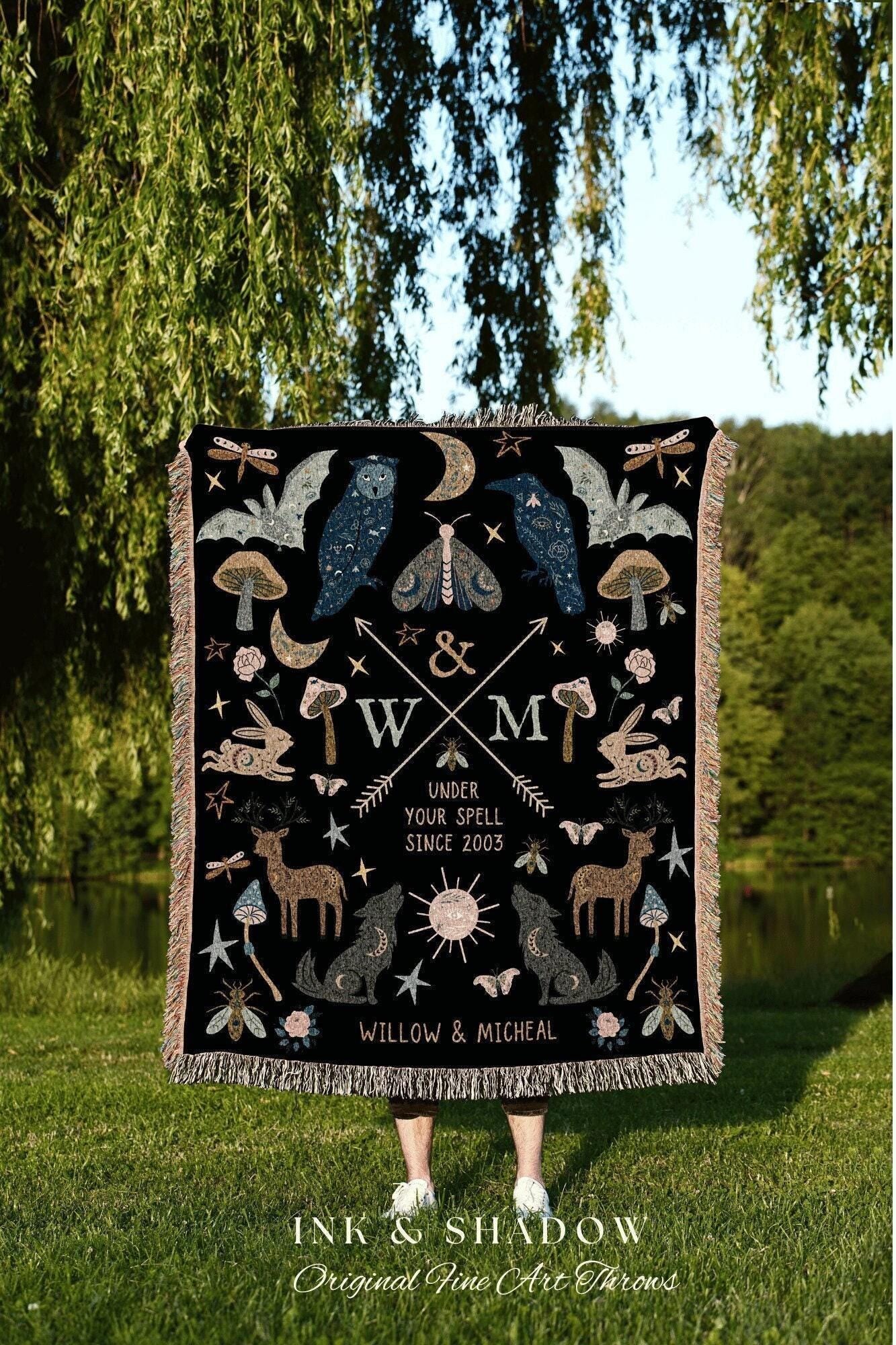 May include: Black throw blanket with a whimsical design featuring an owl, raven, moth, deer, wolf, and other celestial and forest elements. The blanket has a fringed edge and includes the text "UNDER YOUR SPELL SINCE 2003" and "WILLOW & MICHEAL".