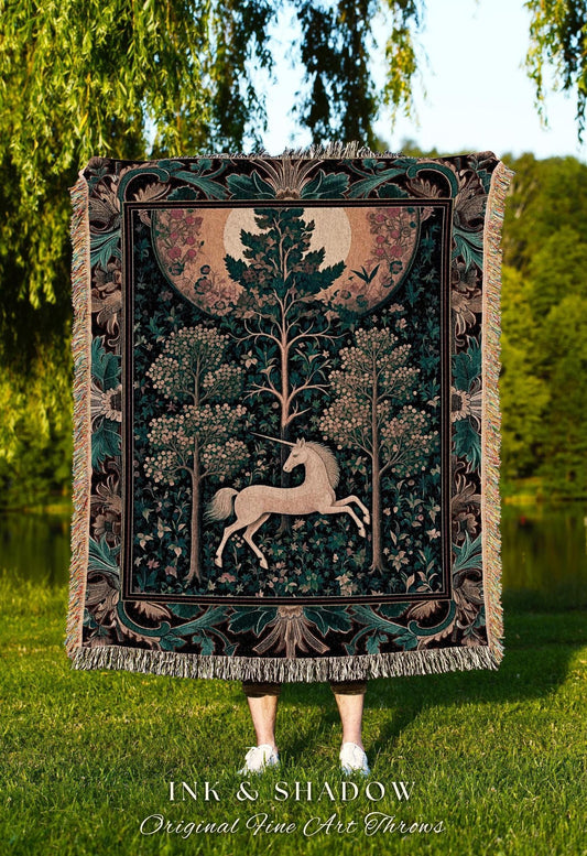 May include: A tapestry throw blanket featuring a unicorn in a forest scene with trees and a full moon. The blanket has a dark green and black border with fringe. The text "INK & SHADOW Original Fine Art Throws" is at the bottom.