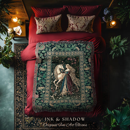May include: A tapestry throw blanket featuring a woman and a unicorn, with a floral border. The throw is displayed on a red bed with matching pillows. The text "INK & SHADOW Original Fine Art Throws" is at the bottom.